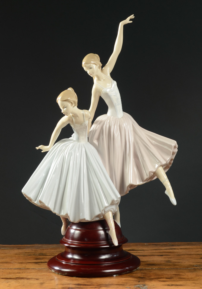 Appraisal: LLADRO PORCELAIN FIGURAL GROUP SCULPTURE raised on wooden pedestal base