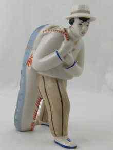 Appraisal: A Ukrainian Soviet ceramic figure of a man carrying a