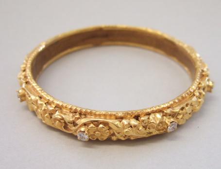 Appraisal: An Indian diamond set bangle decorated with scrollwork within shaped