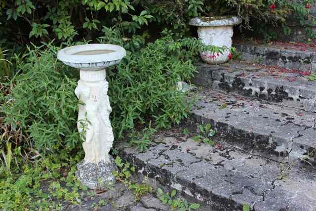 Appraisal: A PAIR OF RECONSTITUTED STONE URNS of classical form approximately