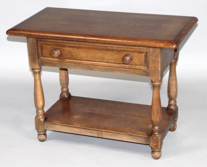 Appraisal: A mid- thC oak low table the overhanging top raised