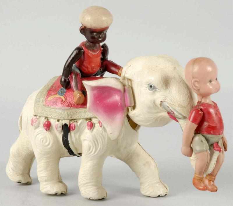 Appraisal: Celluloid Henry on Elephant Wind-Up Toy Description Japanese When wound