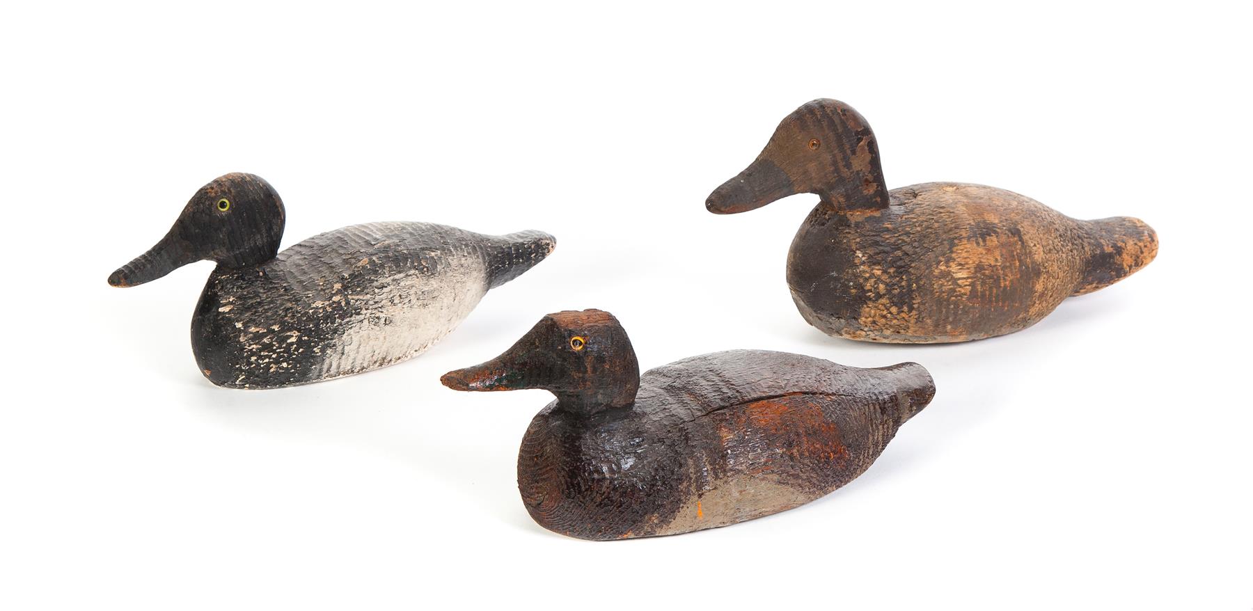 Appraisal: THREE WOODEN DECOYS American st half- th century pine Glass