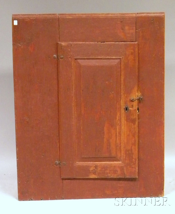 Appraisal: Red-painted Pine Cupboard with Paneled Door the interior with two