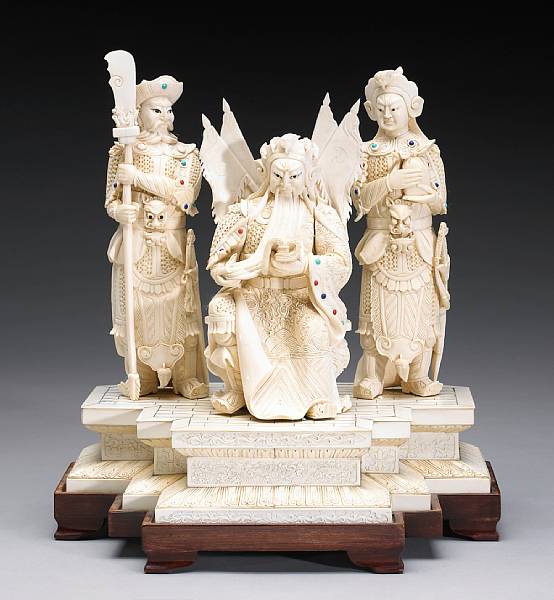 Appraisal: Ivory Carvings Depicting Guan Yu god of war seated between