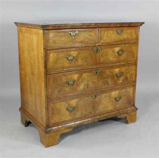 Appraisal: An early th century crossbanded walnut chest of two short