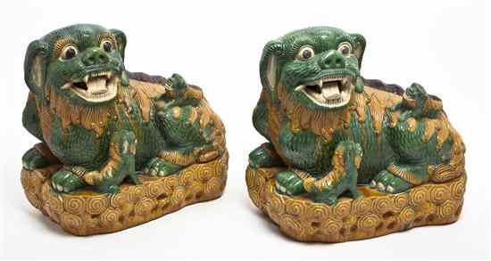 Appraisal: Two Chinese Pottery Models of Fu Dogs having cream green