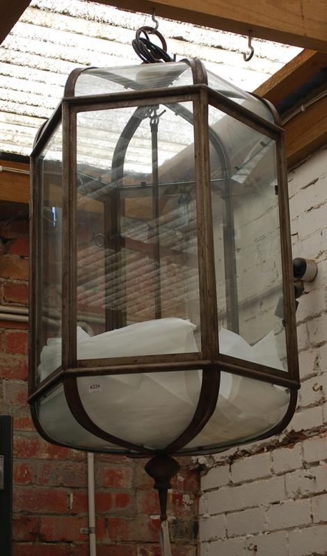 Appraisal: A WROUGHT IRON FRAMED GLAZED LANTERN hexagonal with glazed panelled