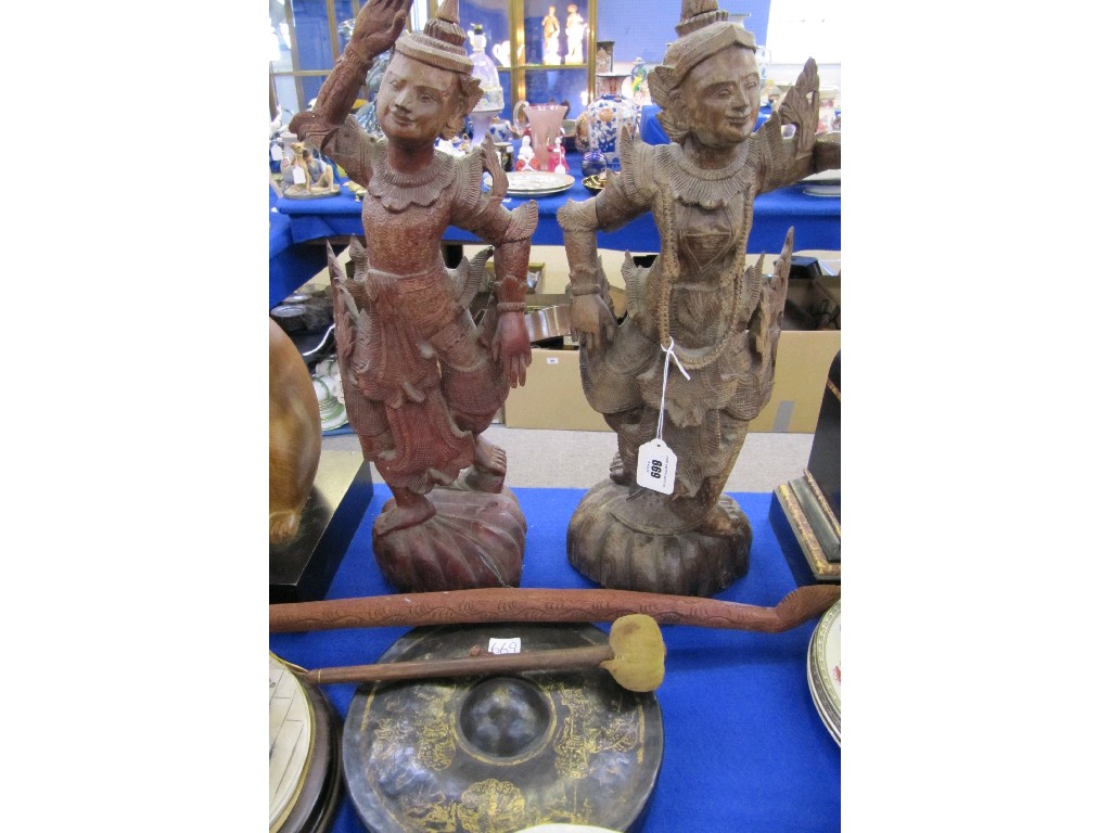 Appraisal: Two carved wooden Indonesian figures and a gong and striker