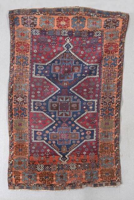 Appraisal: AN EASTERN TURKISH KURDISH RED GROUND RUG with a central