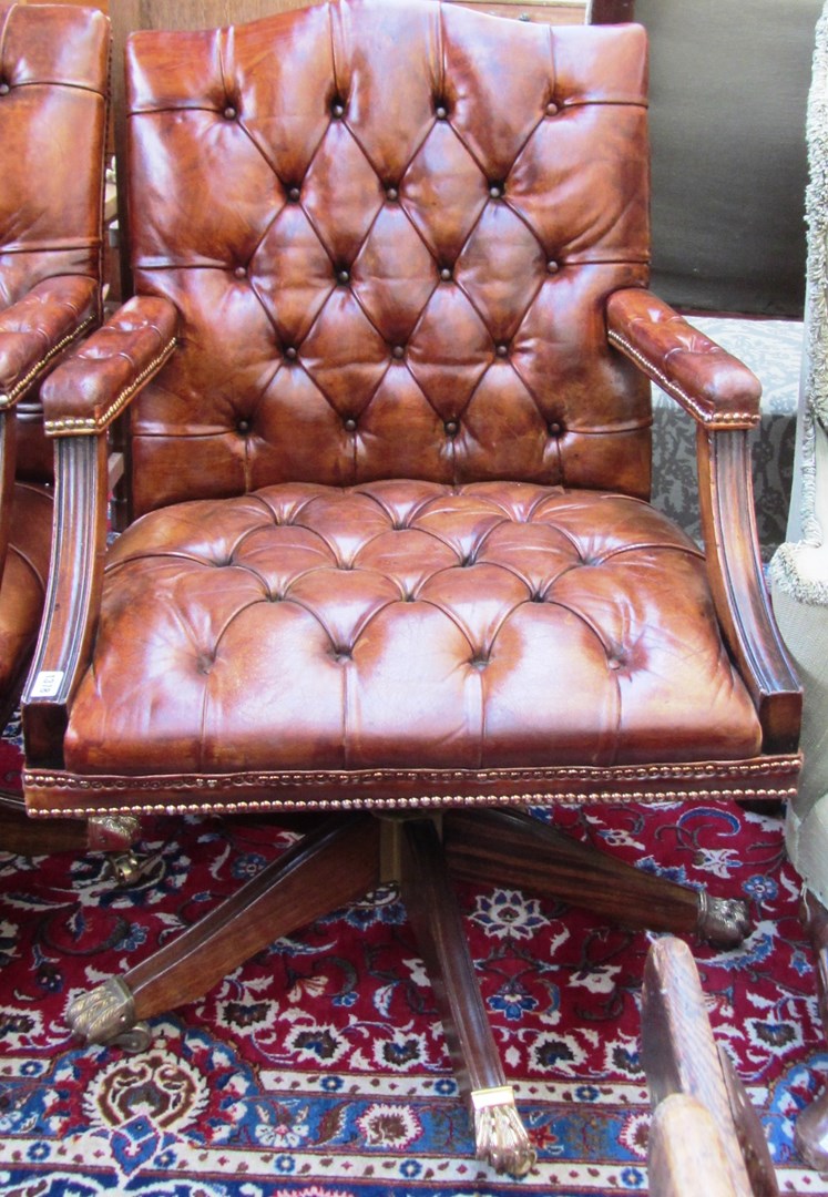 Appraisal: A th century studded brown leather upholstered office swivel chair