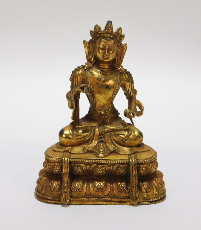 Appraisal: TIBETAN GILT BRONZE SEATED BUDDHA Tibet Early th CenturyDepicts a