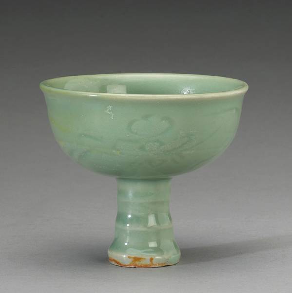 Appraisal: A Lonquan celadon footed cup Ming Dynasty The ribbed foot