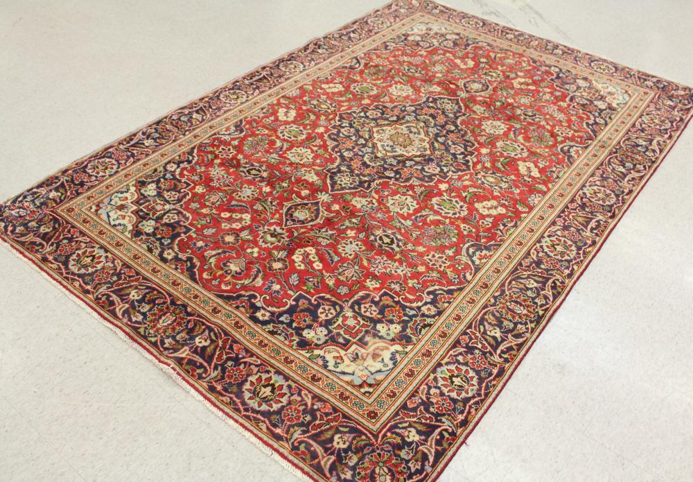 Appraisal: HAND KNOTTED PERSIAN CARPET floral and central floral medallion design