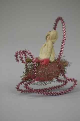 Appraisal: GIRL IN SLEIGH ORNAMENT Germany spun cotton girl with scrap