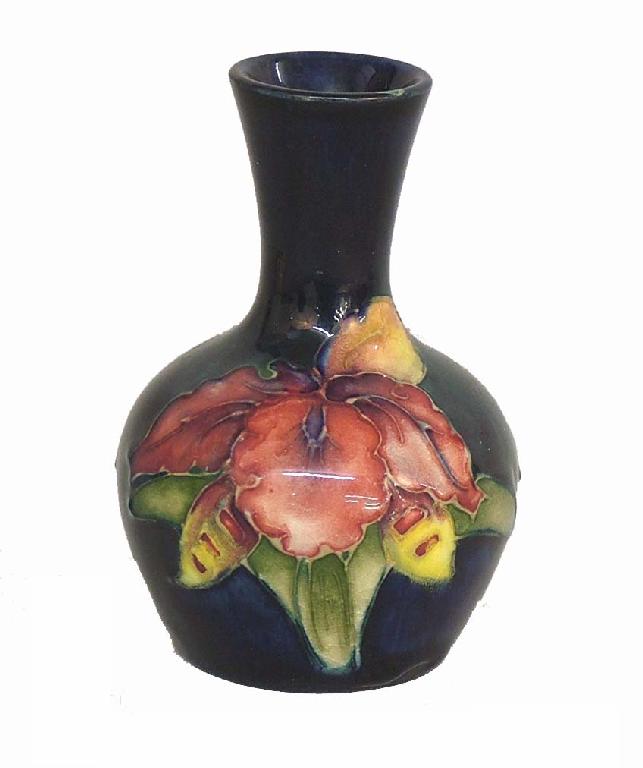 Appraisal: Moorcroft 'Orchid' miniature bottle vase decorated upon a blue ground