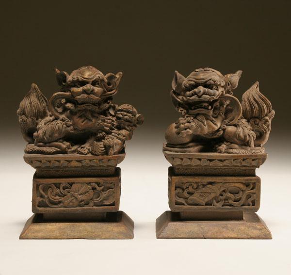 Appraisal: Pair of Chinese hand carved wooden foo dogs the male