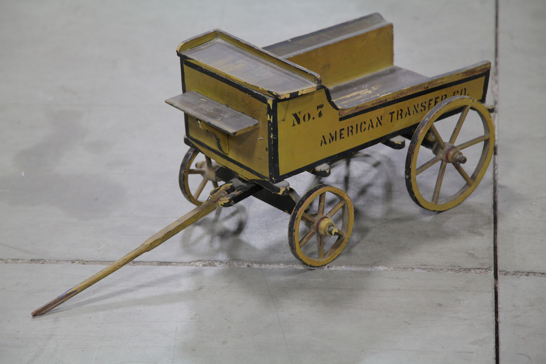 Appraisal: CHILD'S WOODEN WAGON American early th century Yellow painted wagon