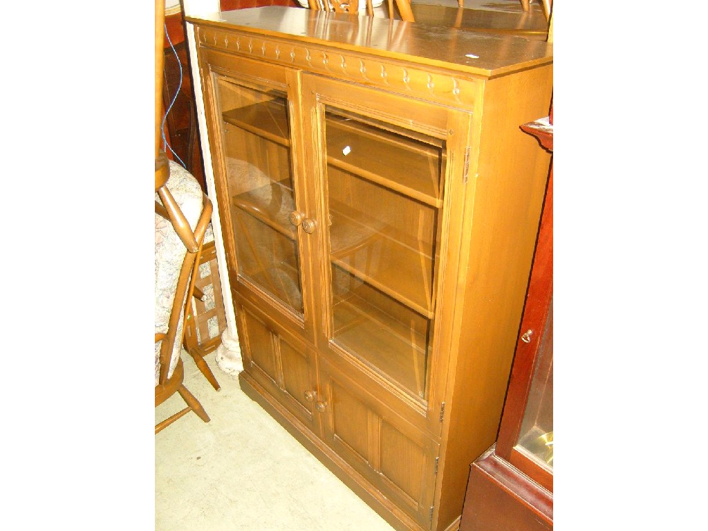 Appraisal: An Ercol elm display cabinet enclosed by a pair of