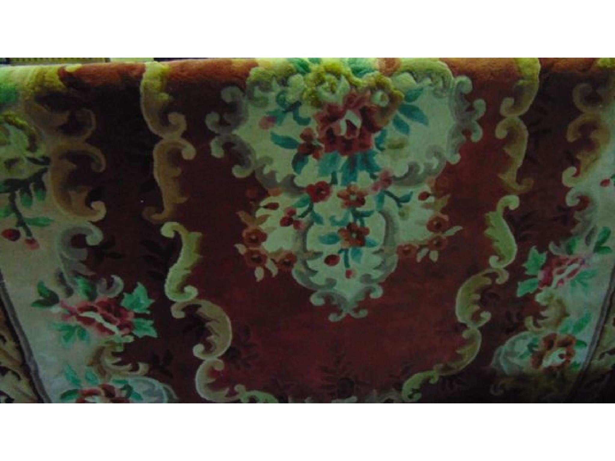 Appraisal: A burgundy ground Chinese wash wool carpet with foliate and