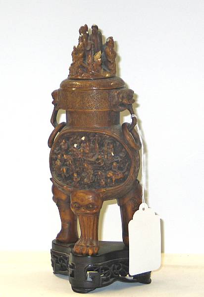 Appraisal: A carved tinted ivory covered tripod censer The finial carved