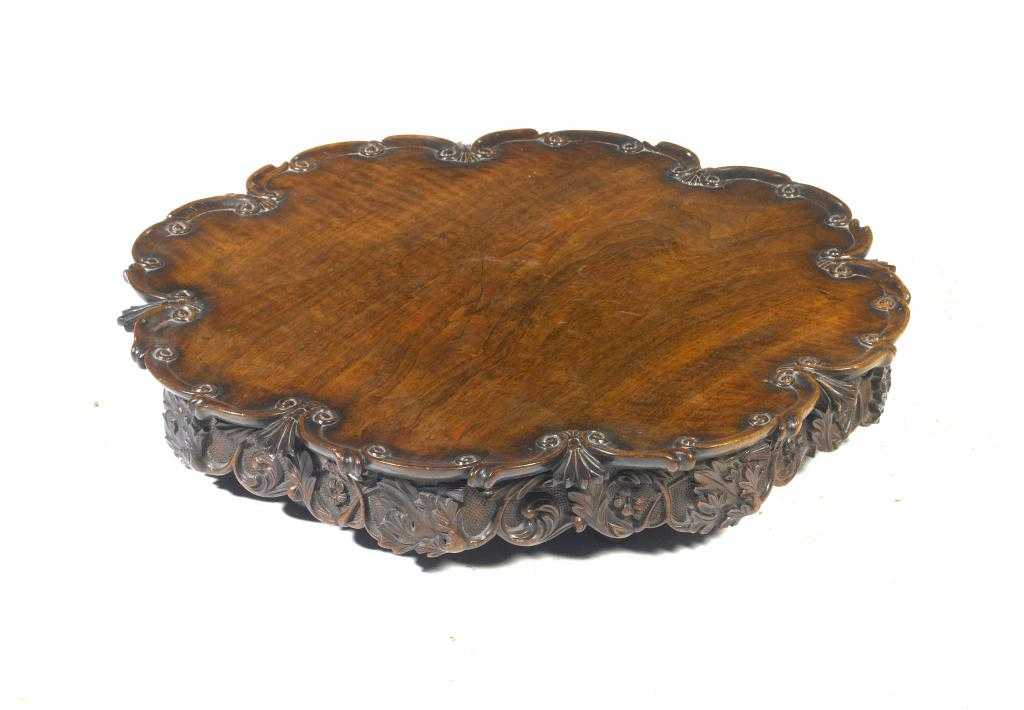 Appraisal: A VICTORIAN BLACK WALNUT LAZY SUSAN with carved scroll border