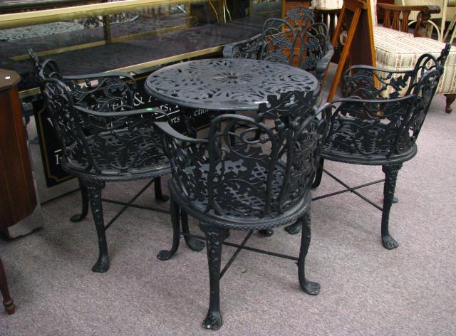 Appraisal: A Cast Iron Patio Table Four Chairs