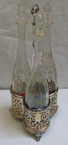 Appraisal: A BOHEMIAN TRIPLE DECANTER SET each of the three paneled