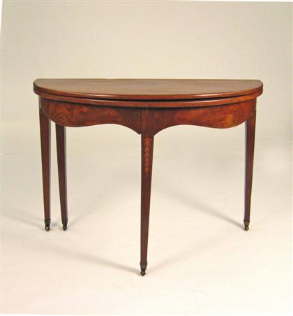 Appraisal: English mahogany games table The D-shaped hinged top above an