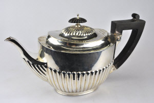 Appraisal: A late Victorian silver oval half-reeded teapot with composition finial