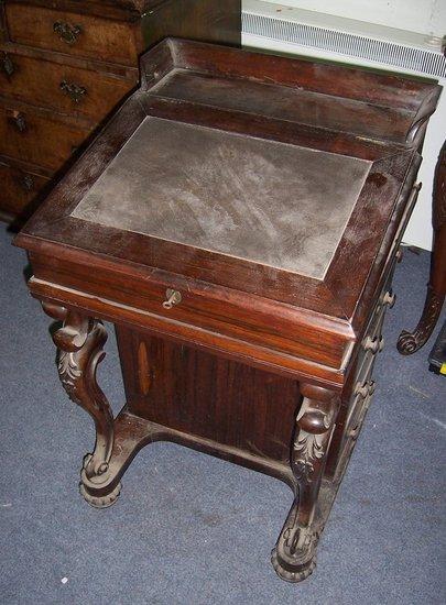 Appraisal: A Victorian rosewood Davenport with galleried back the leather lined