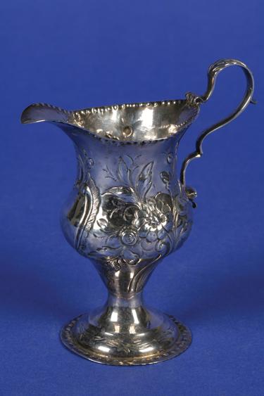 Appraisal: A GEORGE III CREAM JUG of baluster form with a