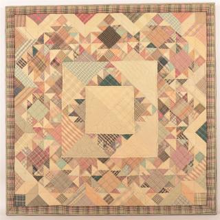 Appraisal: Geometric Pattern Crib Quilt Mounted on a wood stretcher frame