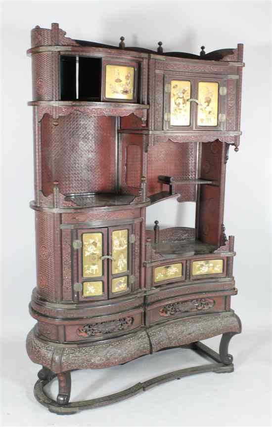 Appraisal: A Japanese carved wood serpentine cabinet with eight lacquered doors