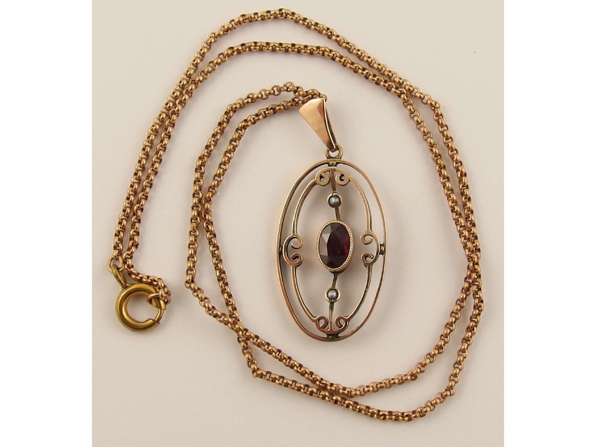 Appraisal: An Edwardian yellow metal garnet and pearl set pendant and