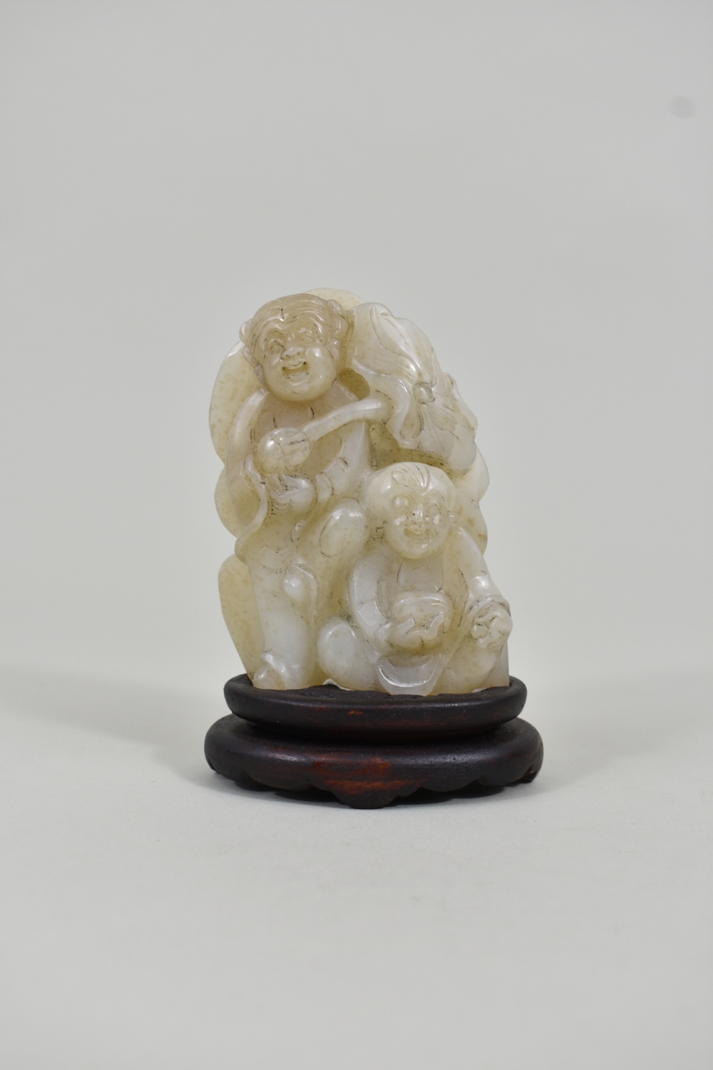 Appraisal: CHINESE CELADON JADE GROUP OF TWO CHILDRENOne holds a lotus