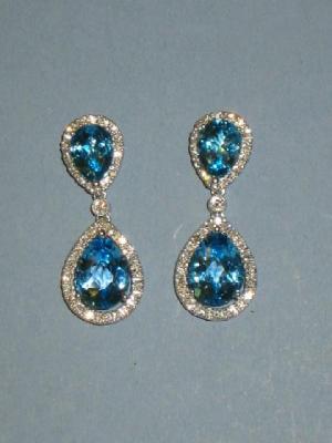 Appraisal: A PAIR OF BLUE TOPAZ AND DIAMOND EARRINGS comprising a