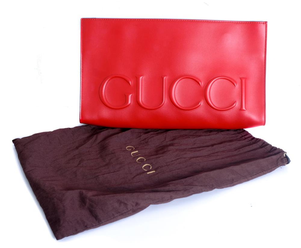 Appraisal: LARGE GUCCI EMBOSSED CLUTCH IN REDGucci Jumbo embossed logo clutch