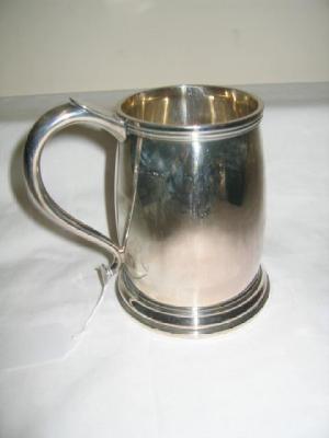 Appraisal: A TANKARD of mildly bellied form with moulded rim scrolled