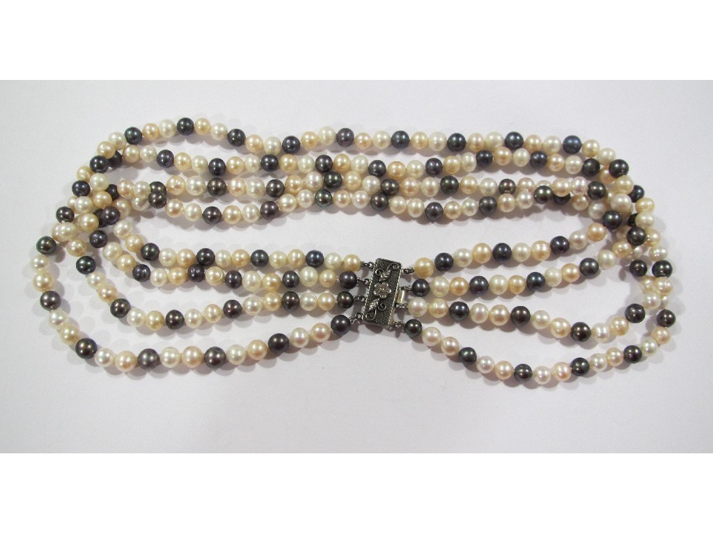 Appraisal: A four strand black white and rose coloured pearl necklace