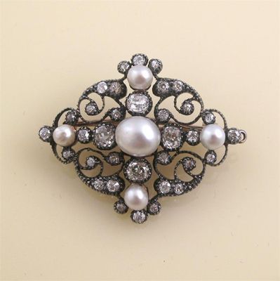 Appraisal: A Victorian open work scroll brooch Set with pearls and