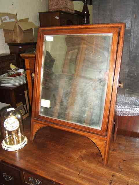 Appraisal: A MAHOGANY SWING DRESSING TABLE MIRROR the bevelled mirror plate