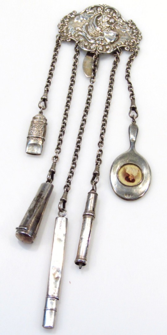 Appraisal: A Victorian silver chatelaine of embossed scroll design decorated with