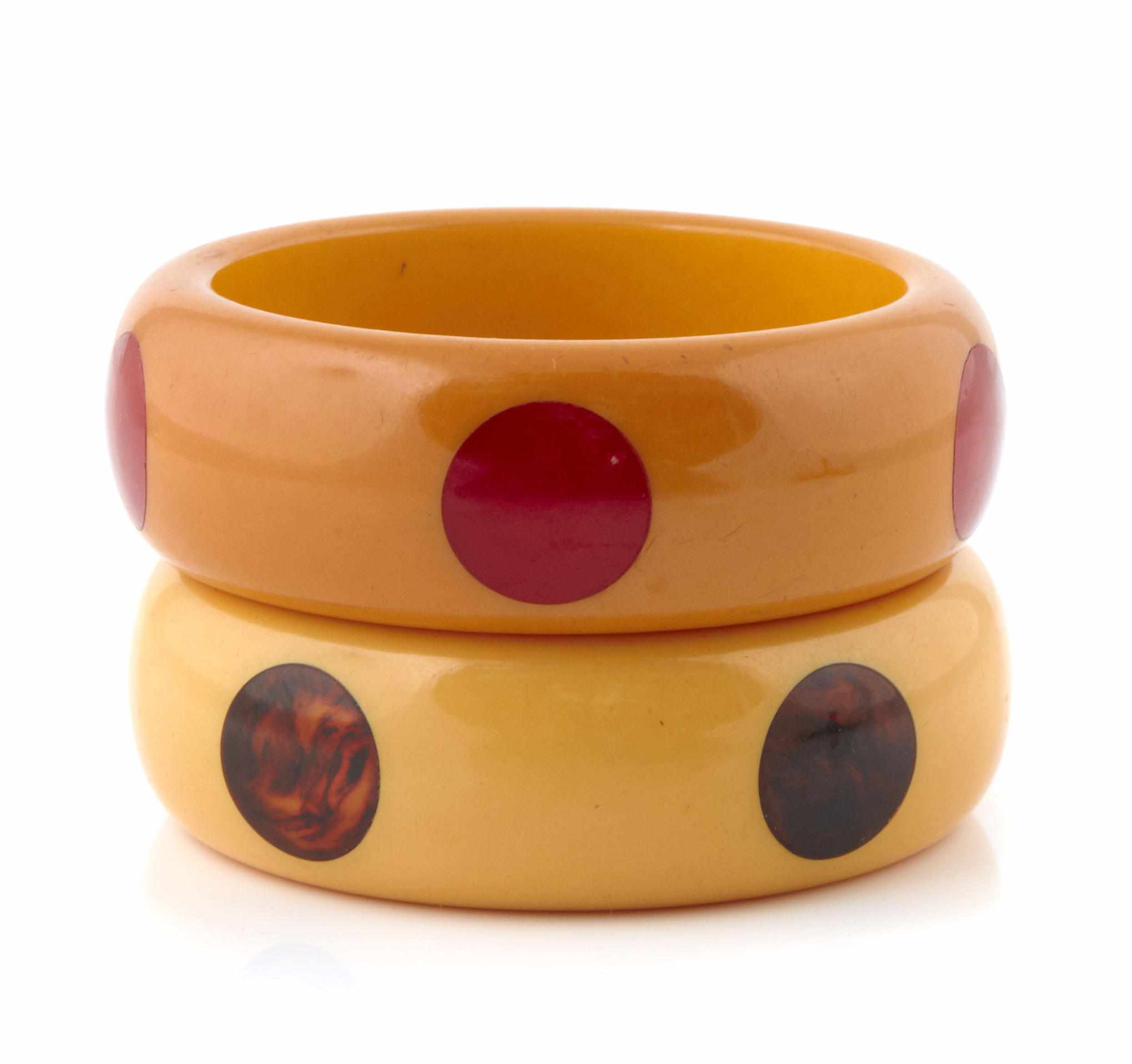 Appraisal: Two Bakelite ''dot'' bangle bracelets each diameter in