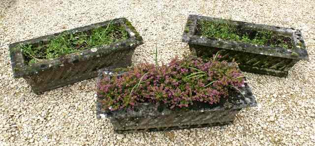 Appraisal: A SET OF THREE WEATHERED COMPOSITION PLANTERS of rectangular basket