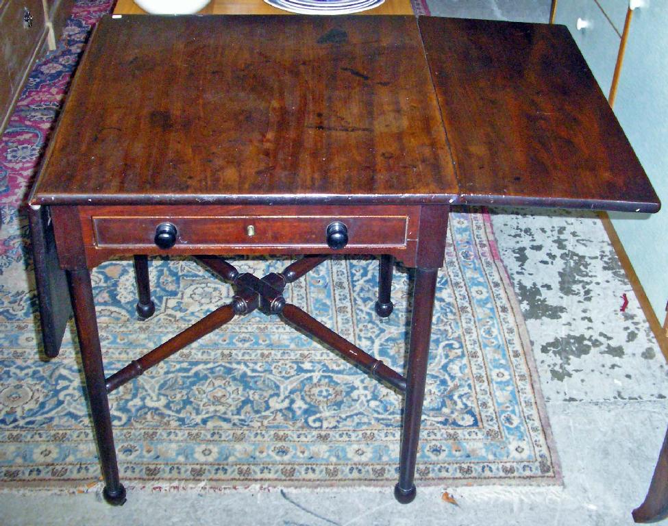 Appraisal: A George III mahogany pembroke table with turned X cross