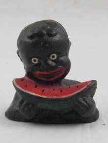 Appraisal: Black Americana A cast iron figure of a boy eating