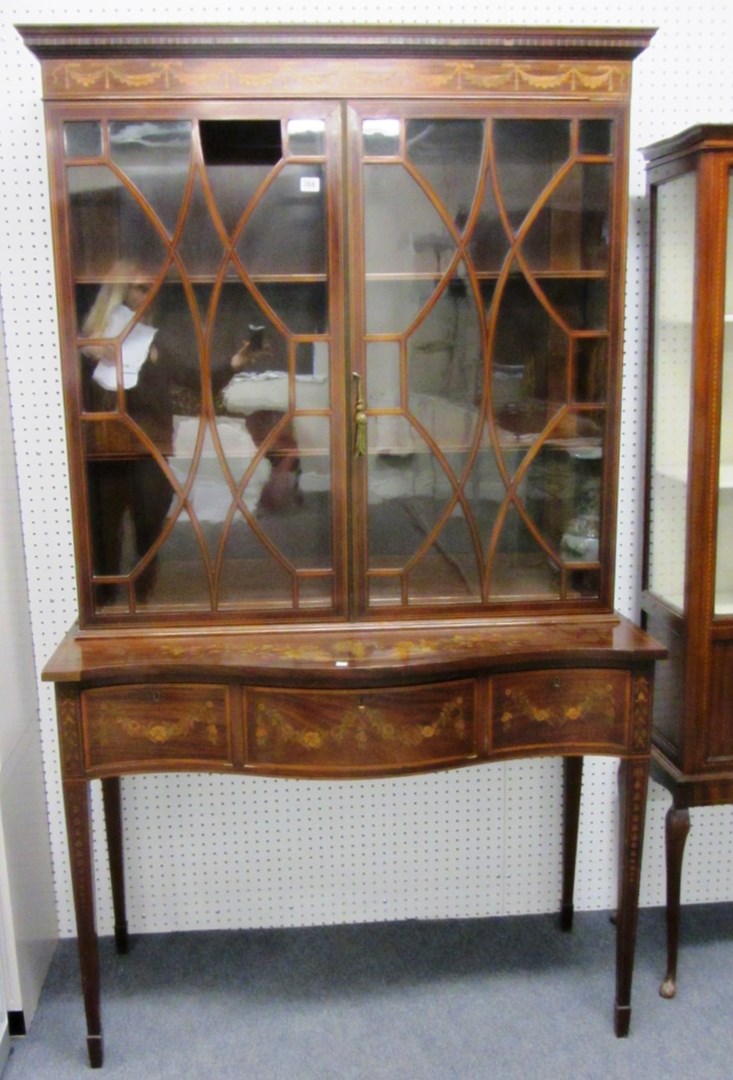 Appraisal: An Edwardian marquetry inlaid mahogany two door display cabinet on