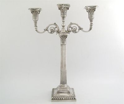 Appraisal: A Corinthian column candleabrum with three lights and two scrolling