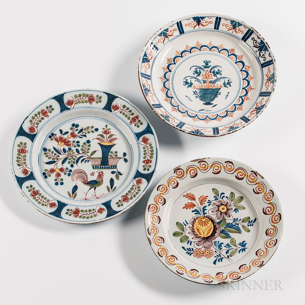 Appraisal: Three Polychrome Decorated Tin-glazed Earthenware Chargers Three Polychrome Decorated Tin-glazed